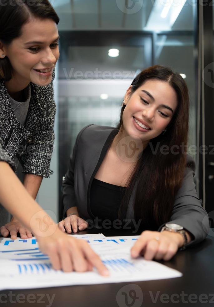 Both of young female entrepreneurs. Is exchanging ideas with new work that is going to be presented to executive management photo