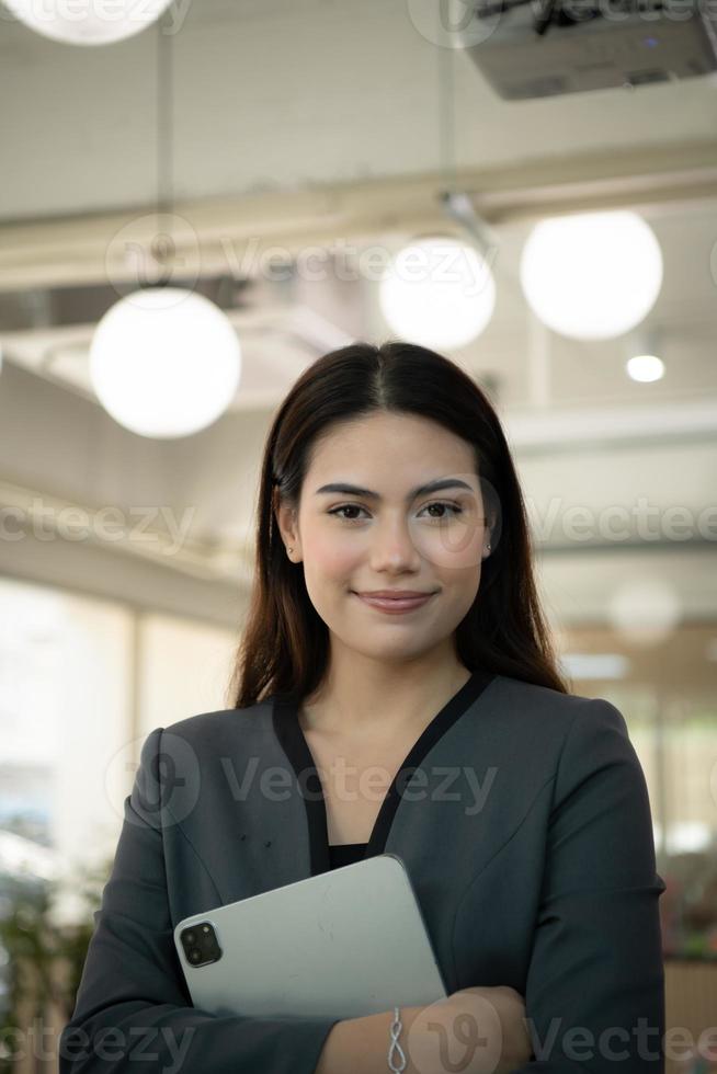 Portrait of Business female rookie in the new entrepreneurial with a tablet as a tool to help in the work photo