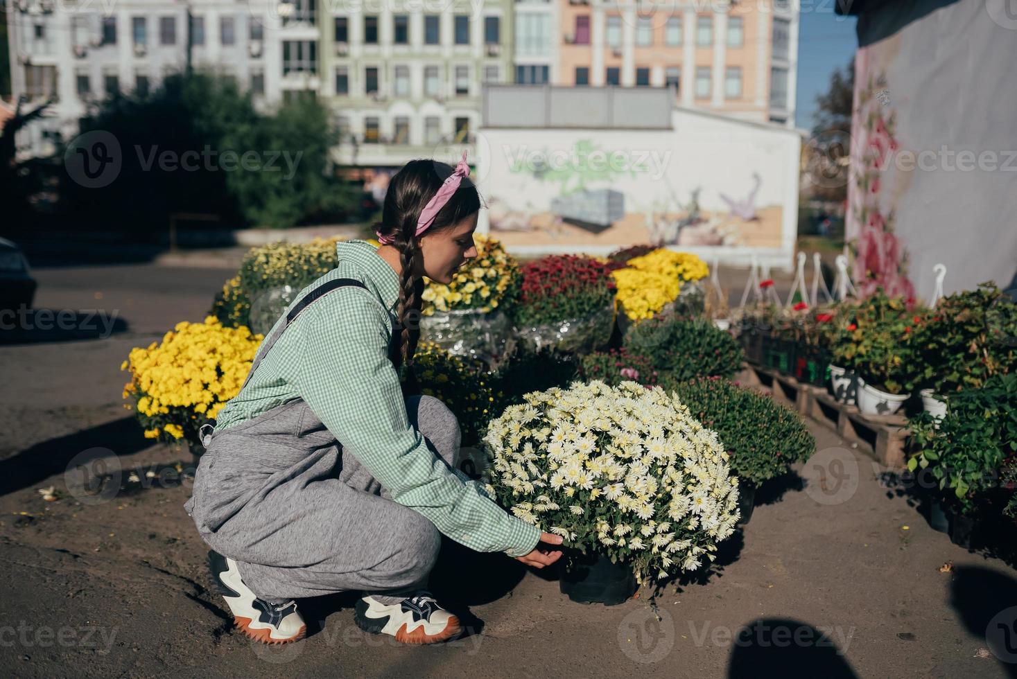 Young women selling flower at the street market place. photo