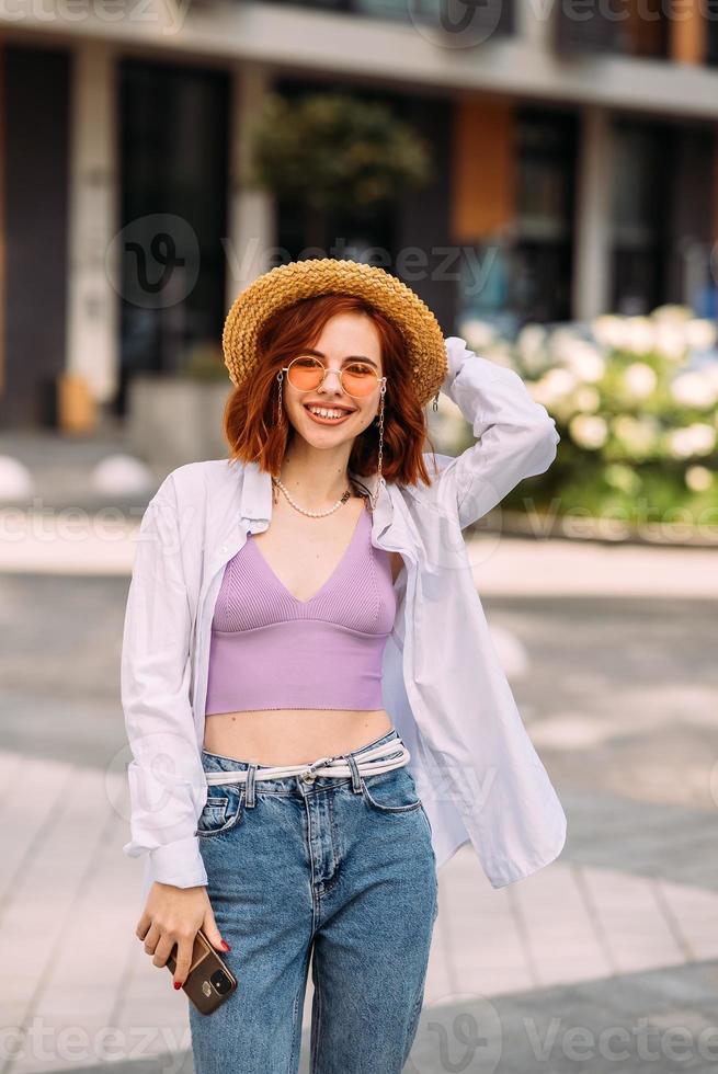A red-haired woman poses for the camera photo