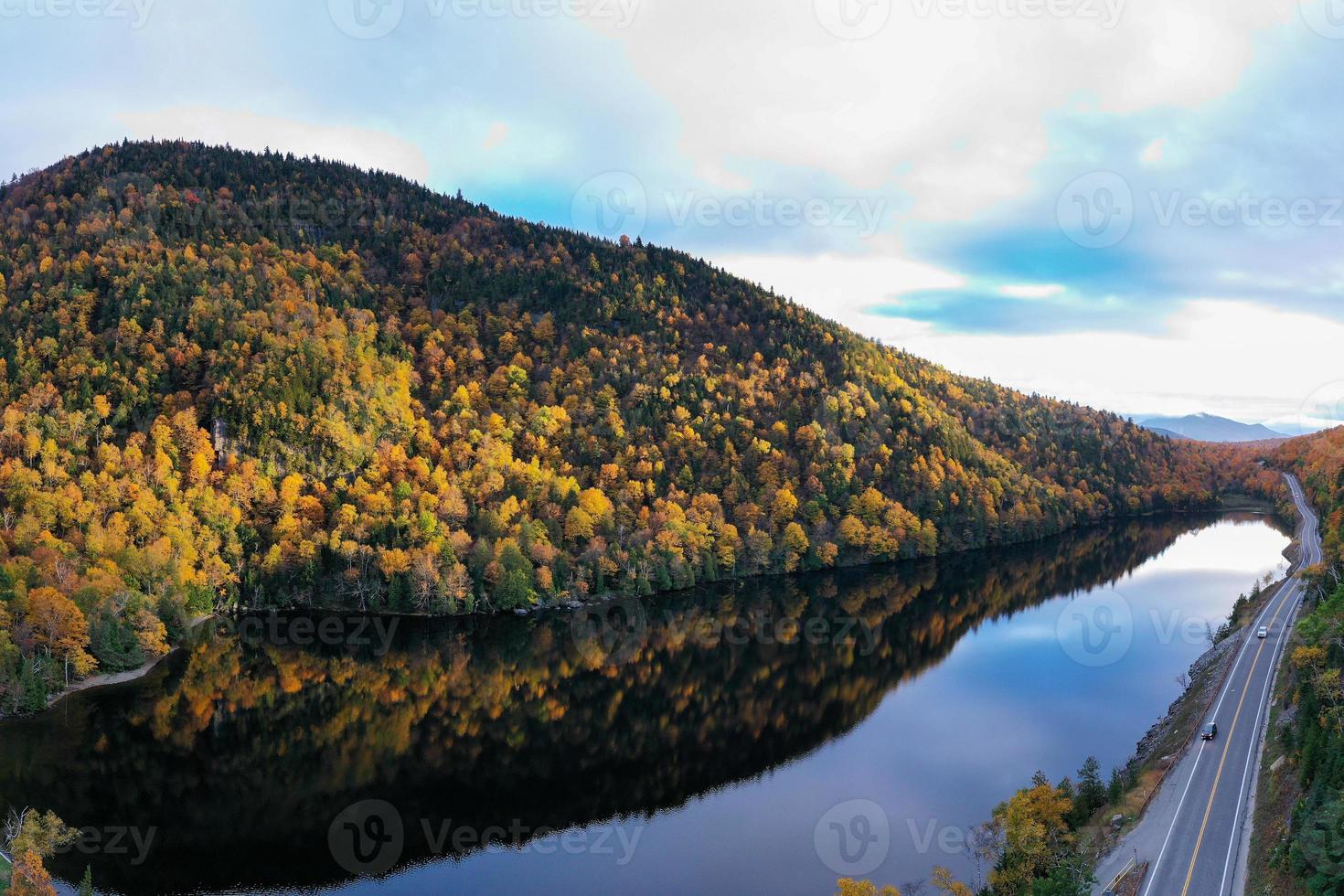 Peak fall foliage in Keene, New York by Cascade Lake. photo