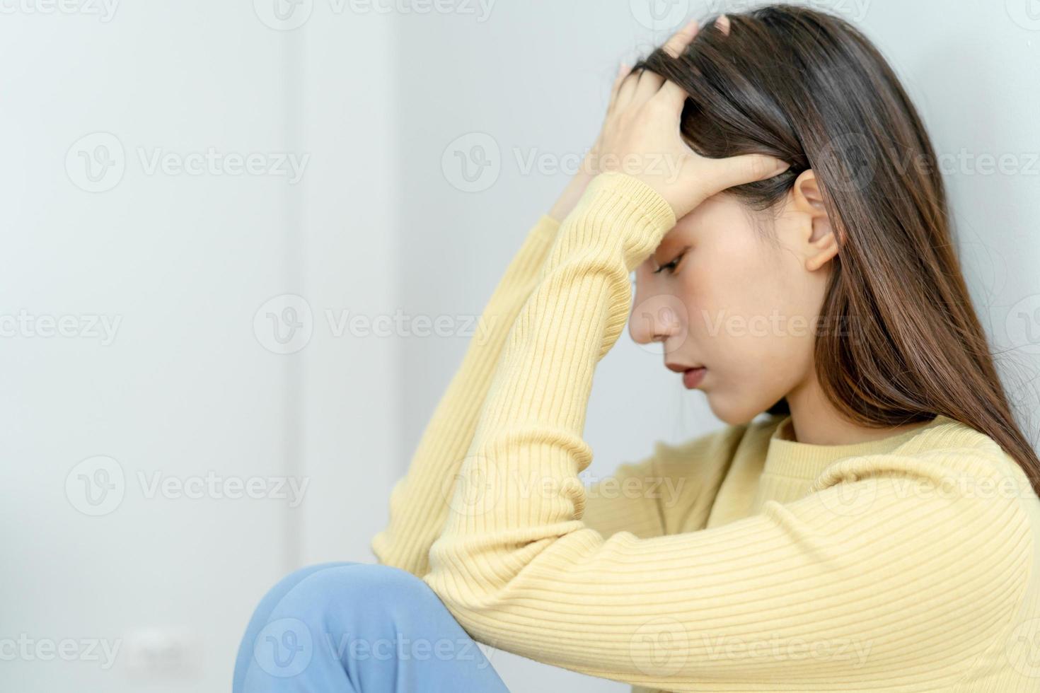 Depression and mental illness. Asian woman disappointed, sad after receiving bad news. Stressed girl confused with unhappy problems, arguing with boyfriend, cry and worry about unexpected pregnancy. photo