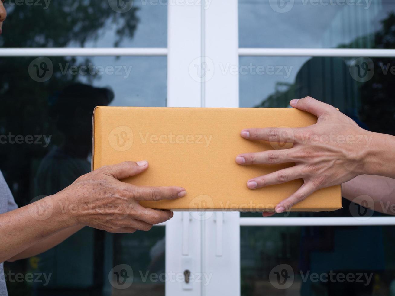 The delivery person is sending the parcel box to the recipient. photo