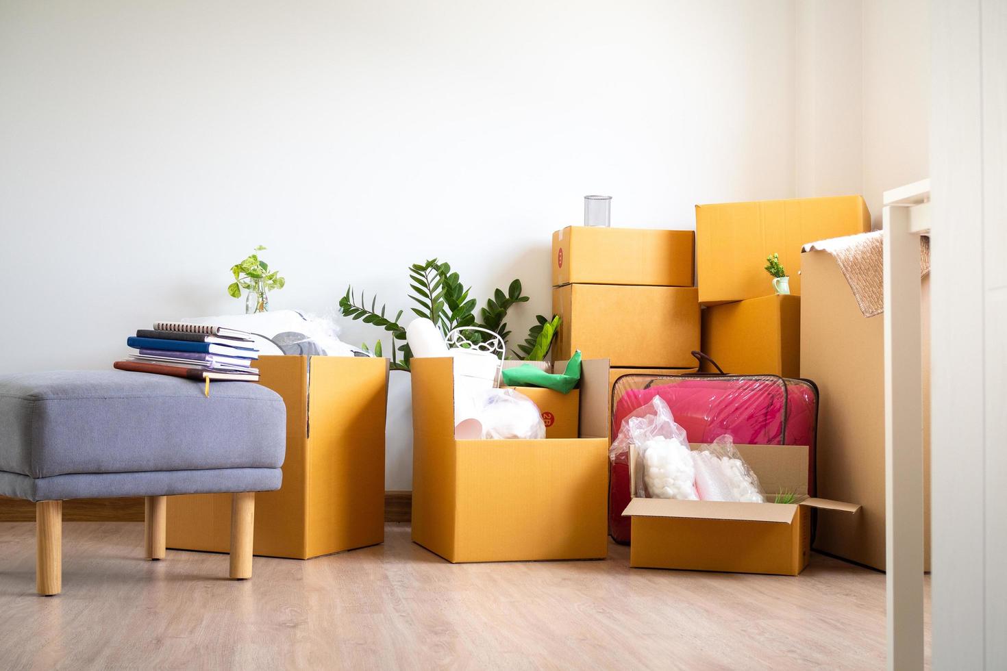 Box for personal belongings and furniture. Moving boxes in a new house photo