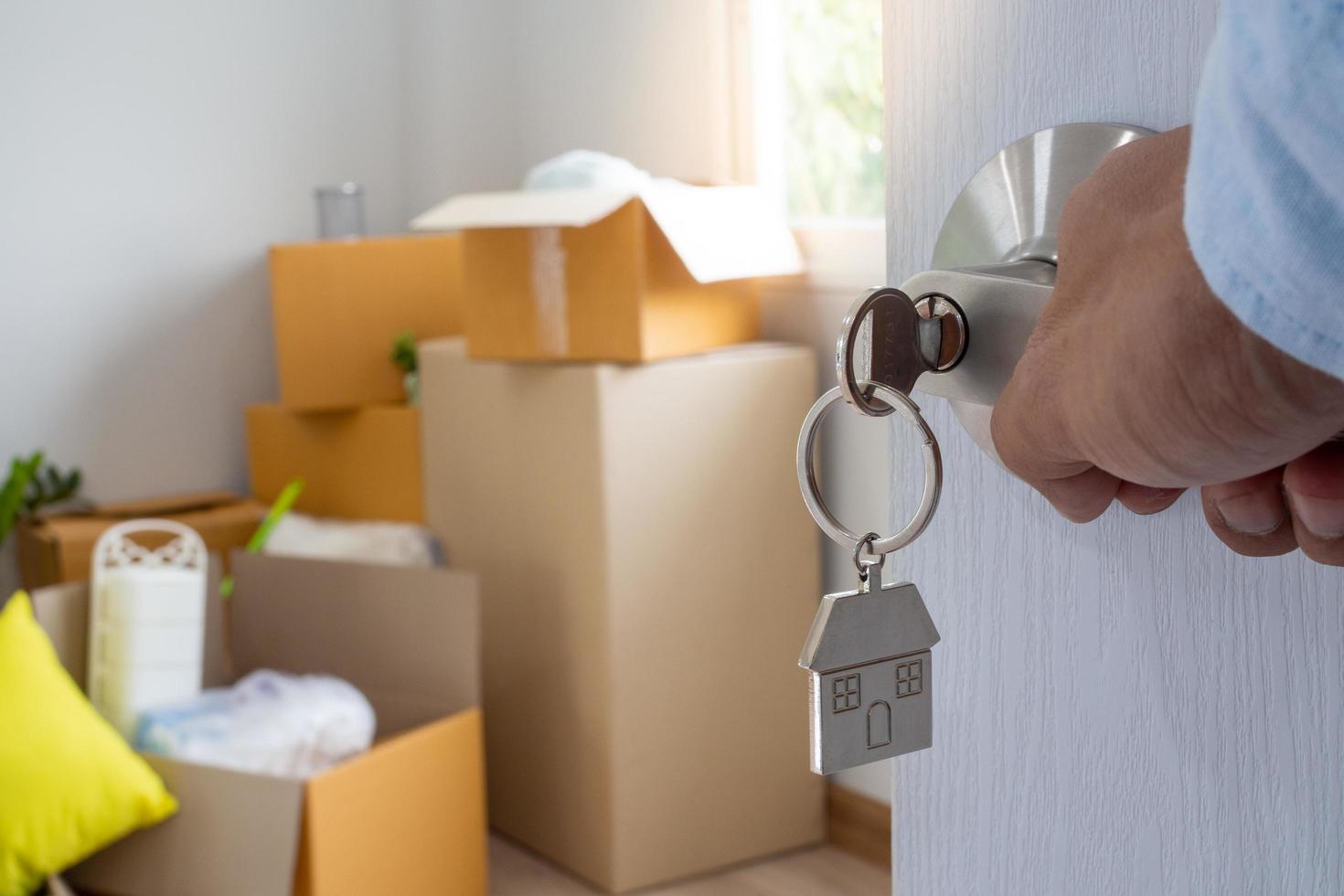 The new home owner opens the door of the room. Inside the room there are personal belongings that are going to be moved to keep correctly. House moving concept. photo