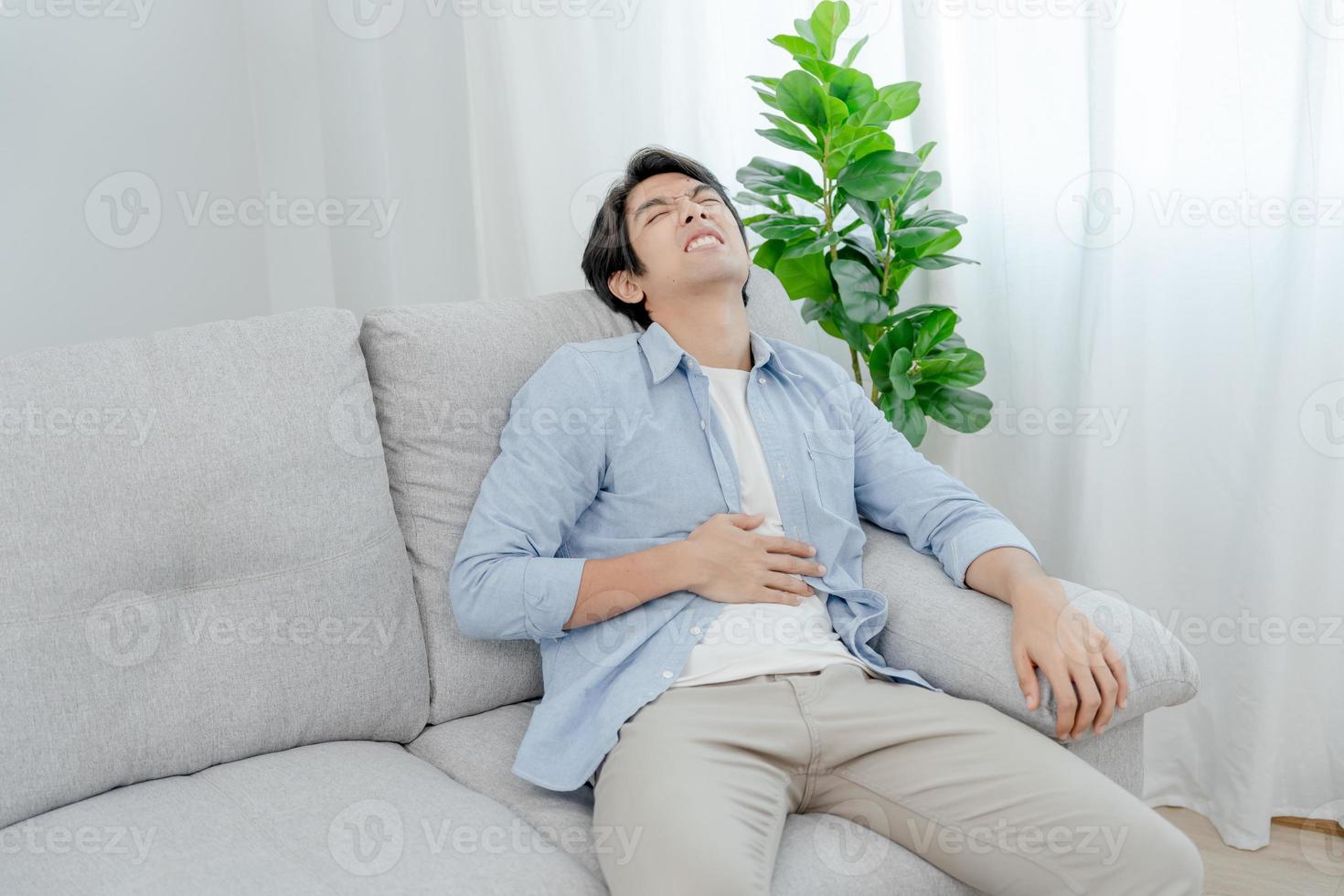 stomach ache. Asian men have abdominal pain, indigestion, gastritis, menstrual cramps, flatulence, diarrhea, distention, colon cancer, belly inflammation problem, suffer food poisoning, abdomen photo