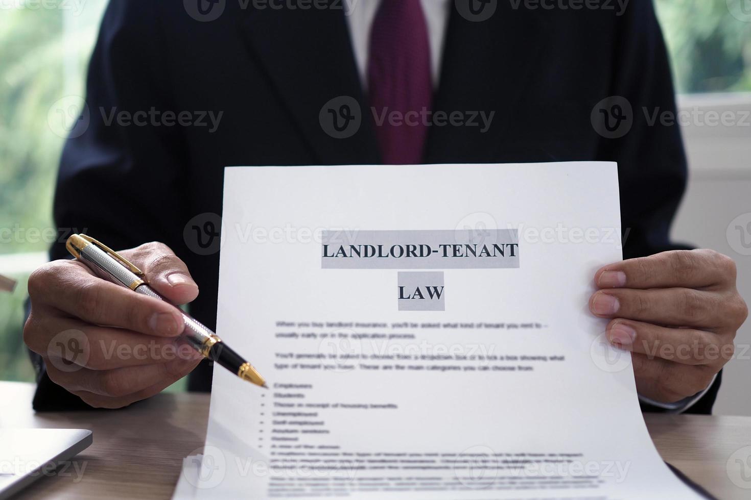 House salesman is showing Landlord-Tenant Law document. photo