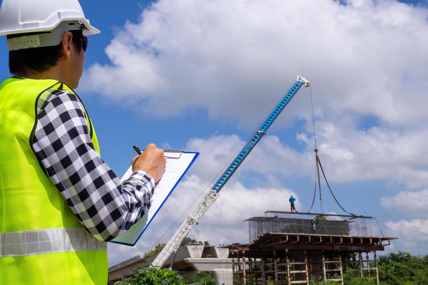 The inspectors or engineers are checking the work of the contractor team to build a bridge over the road. photo