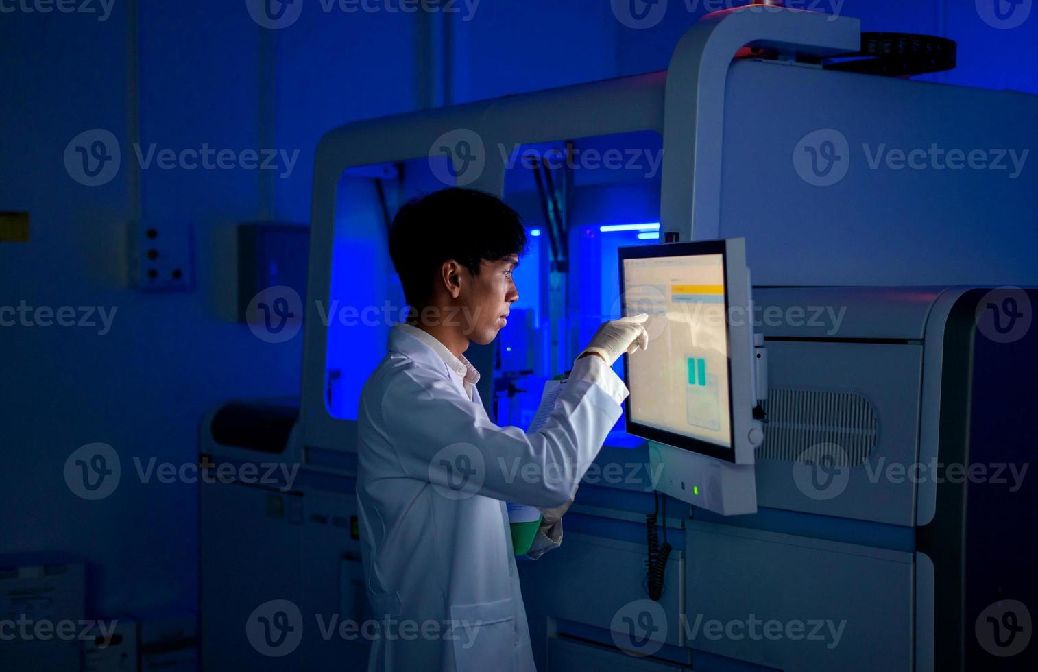 young scientist working with automation blood analyzer report in