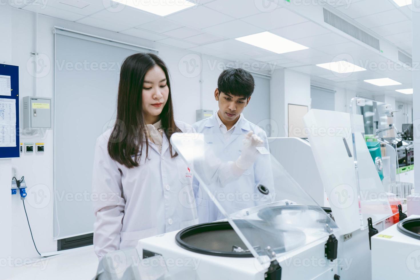 young female scientists open centrifuge in medical laboratory photo