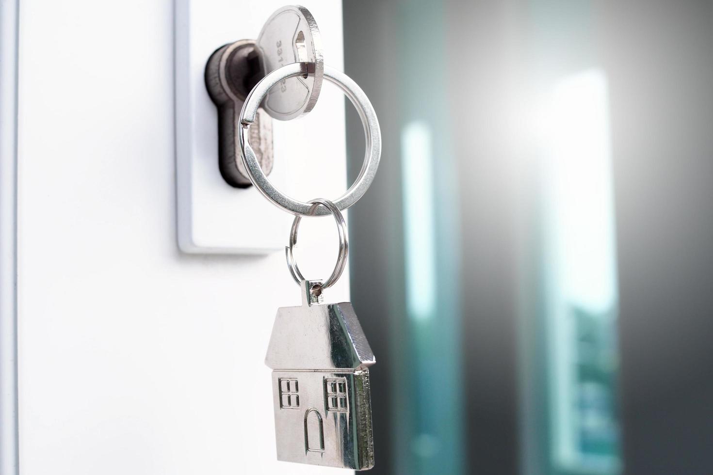 The house key for unlocking a new house is plugged into the door. photo