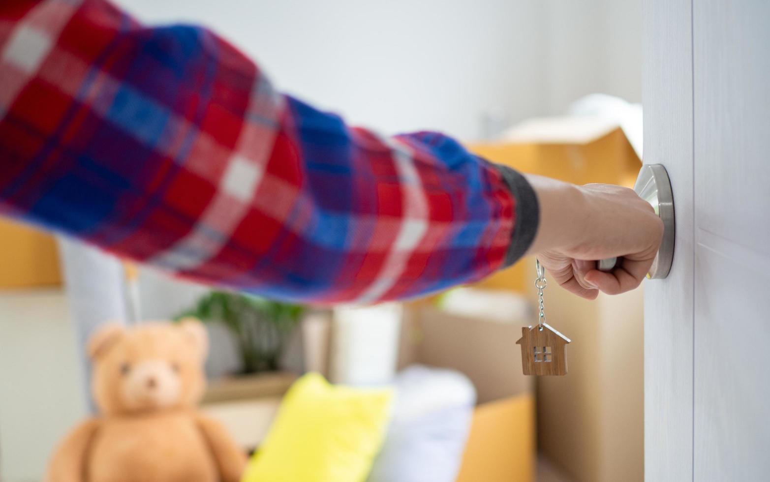 The new home owner opens the door of the room. Inside the room there are personal belongings that are going to be moved to keep correctly. House moving concept. photo