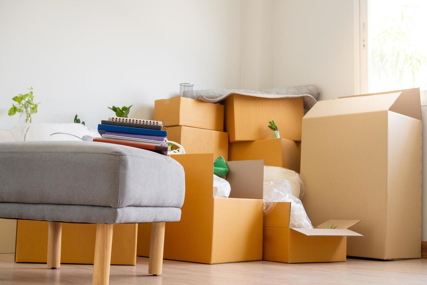 Box for personal belongings and furniture. Moving boxes in a new house photo