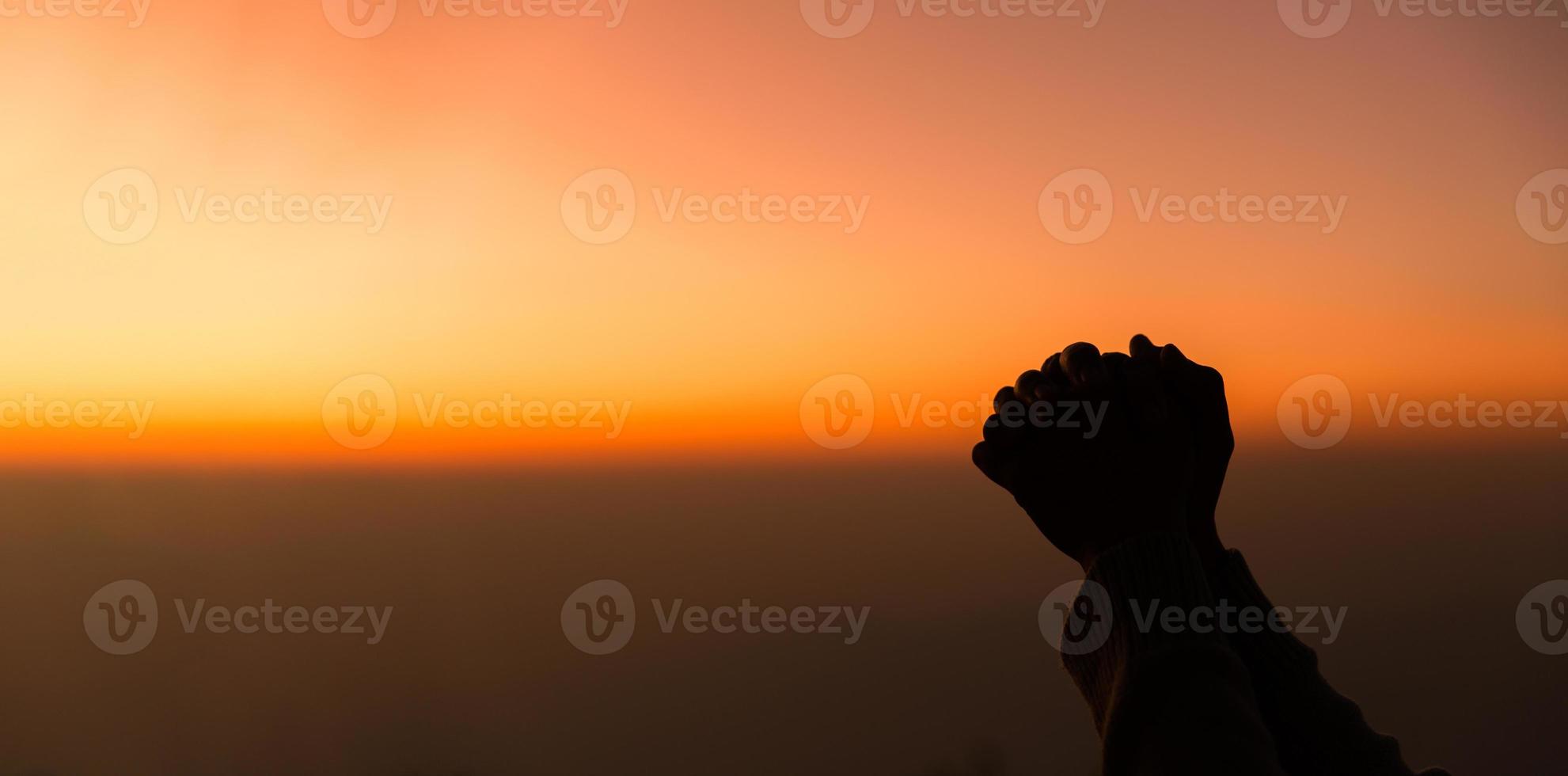 Silhouette of woman hand praying spirituality and religion, female worship to god. banner with copy space. Religious people are humble to God. Christians have hope faith and faith in god. photo