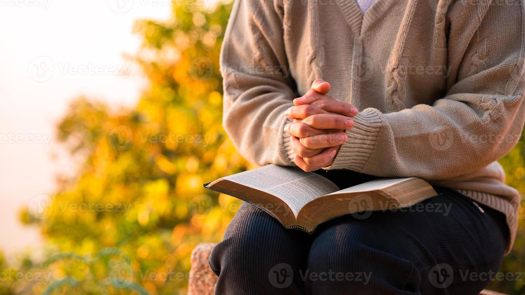 Silhouette of woman kneeling down praying for worship God at sky background. Christians pray to jesus christ for calmness. In morning people got to a quiet place and prayed. copy space. photo