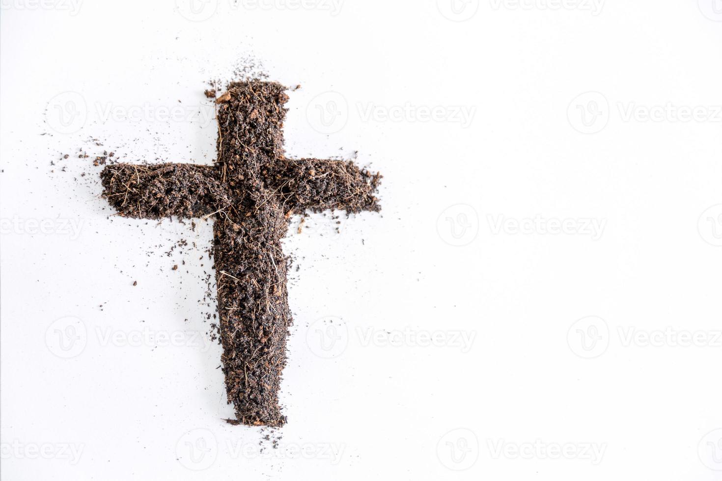 Christian cross or crucifix drawing in ash, dust or sand as symbol of religion, sacrifice, redemption, Jesus Christ, ash wednesday, lent, Good Friday, Easter with Church is devoted to fasting photo