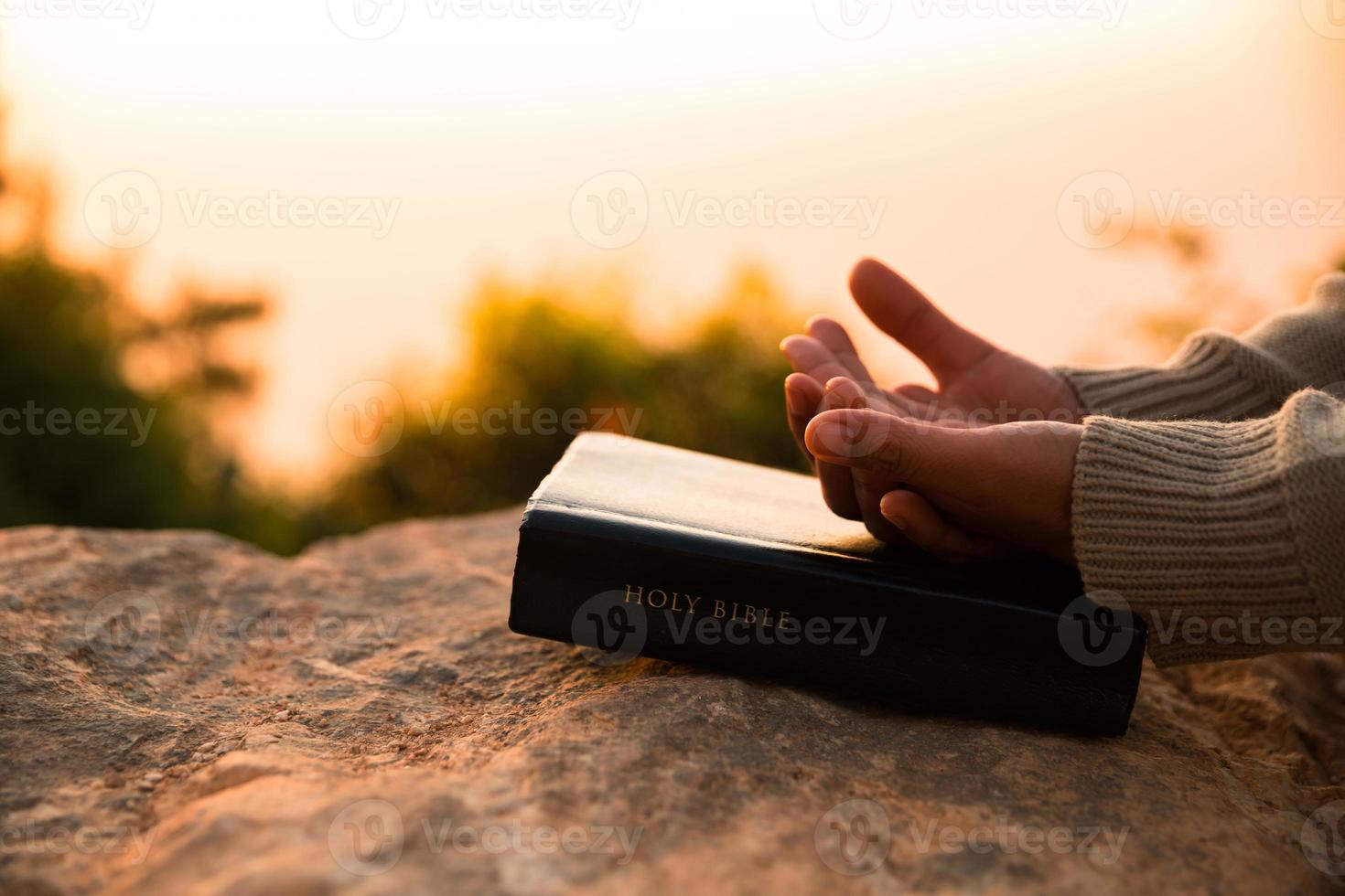 Silhouette of woman kneeling down praying for worship God at sky background. Christians pray to jesus christ for calmness. In morning people got to a quiet place and prayed. copy space. photo
