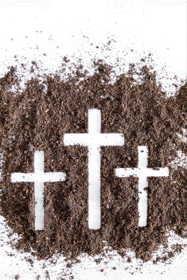 Christian cross or crucifix drawing in ash, dust or sand as symbol of religion, sacrifice, redemption, Jesus Christ, ash wednesday, lent, Good Friday, Easter with Church is devoted to fasting photo