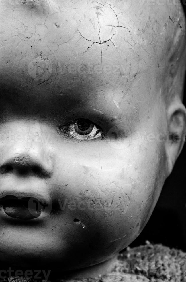 Close Up Scary Doll Face with Cracked Head photo