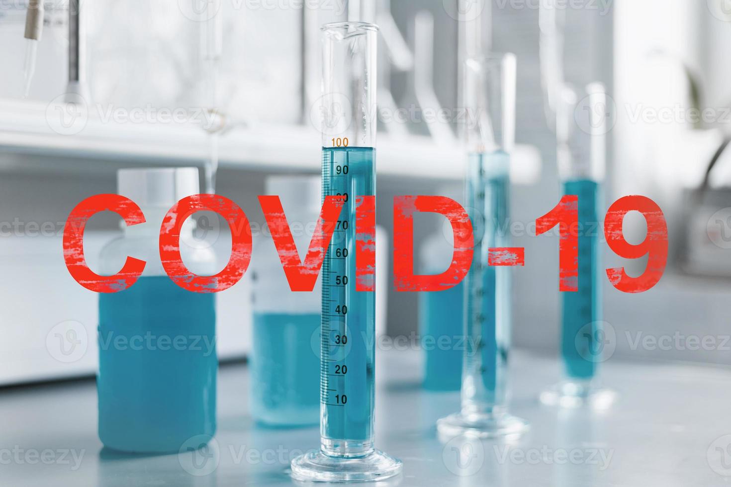 Laboratory with equipment for chemical analysis, detection and treatment of coronavirus infection, labeled COVID-19. photo