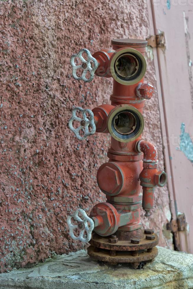 Fire hydrant near red wall photo