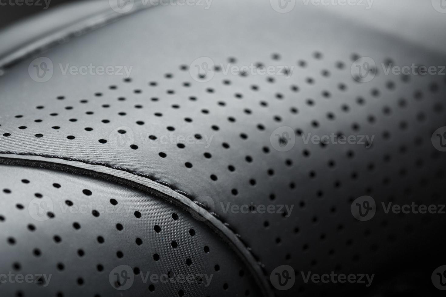 Perforated material made of black imitation leather in full screen photo