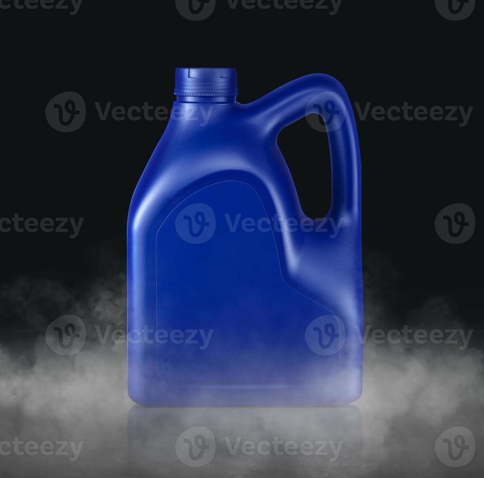 Plastic canister for machine oil with cold vapor an isolated dark studio background photo