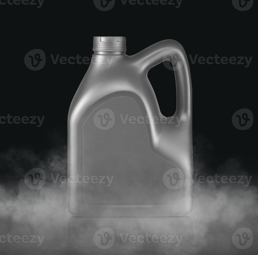 Plastic canister for machine oil with cold vapor an isolated dark studio background photo