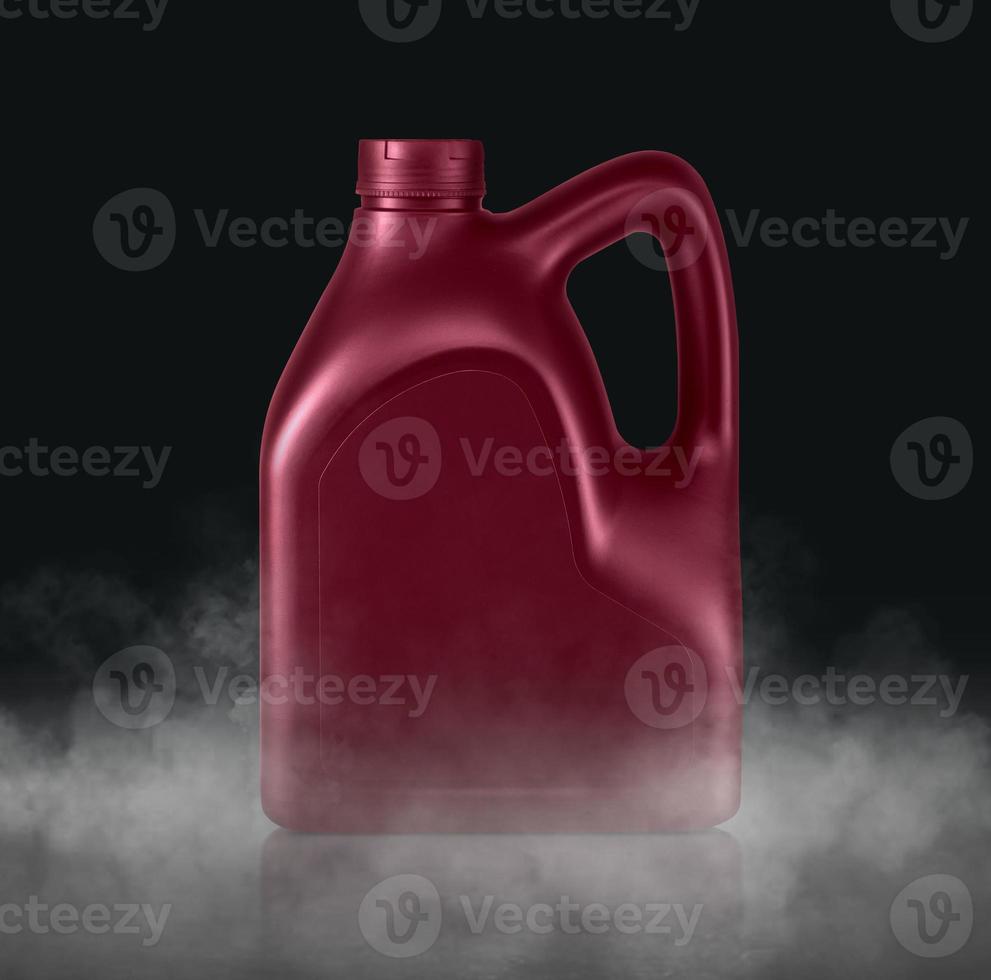 Plastic canister for machine oil with cold vapor an isolated dark studio background photo