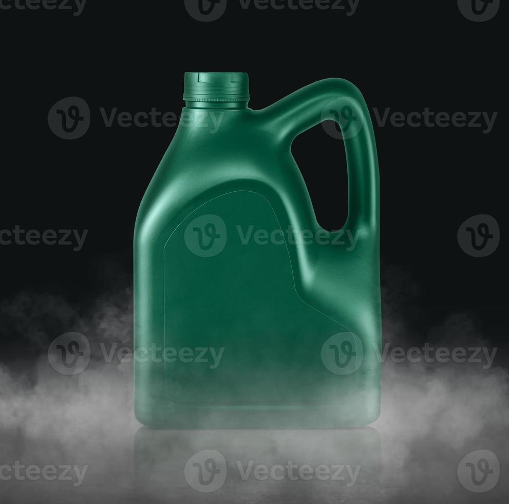 Plastic canister for machine oil with cold vapor an isolated dark studio background photo