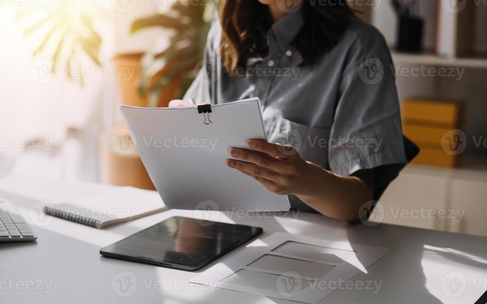 Beautiful lady blogger showing clothes in front of the camera to recording vlog video live streaming at her shop. Online Shopping Cart notion. photo