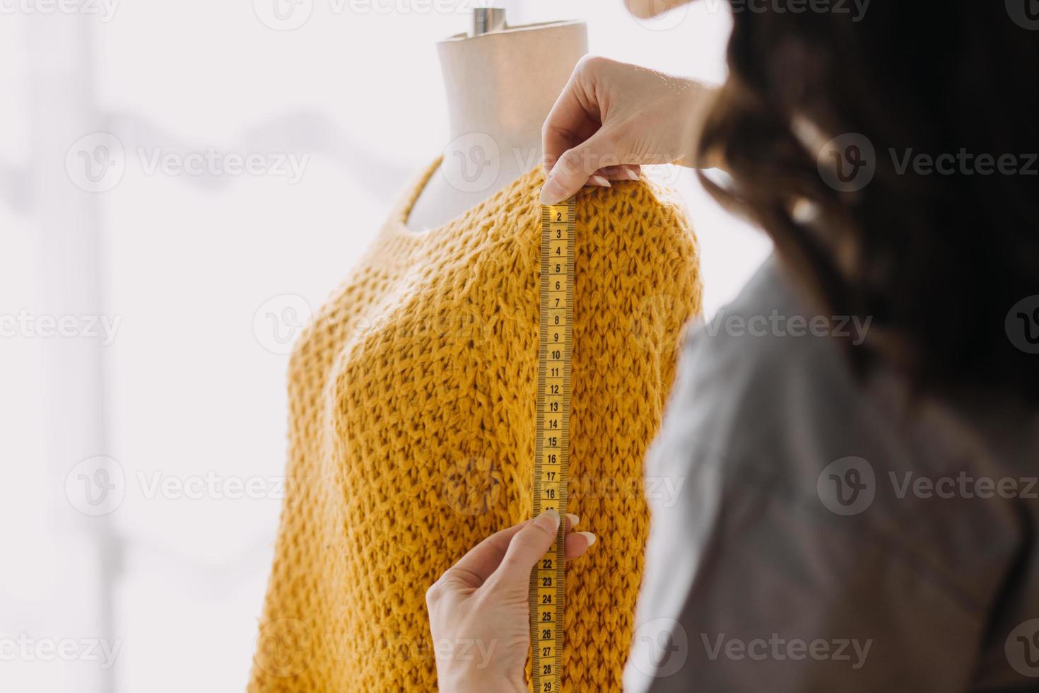 Beautiful lady blogger showing clothes in front of the camera to recording vlog video live streaming at her shop. Online Shopping Cart notion. photo