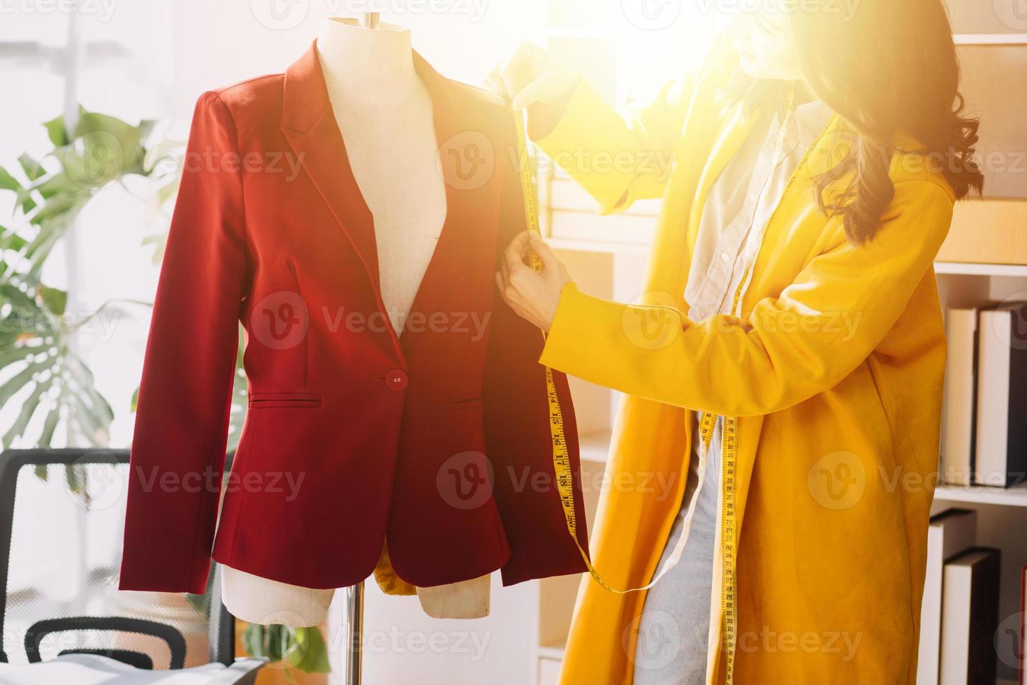 Beautiful lady blogger showing clothes in front of the camera to recording vlog video live streaming at her shop. Online Shopping Cart notion. photo