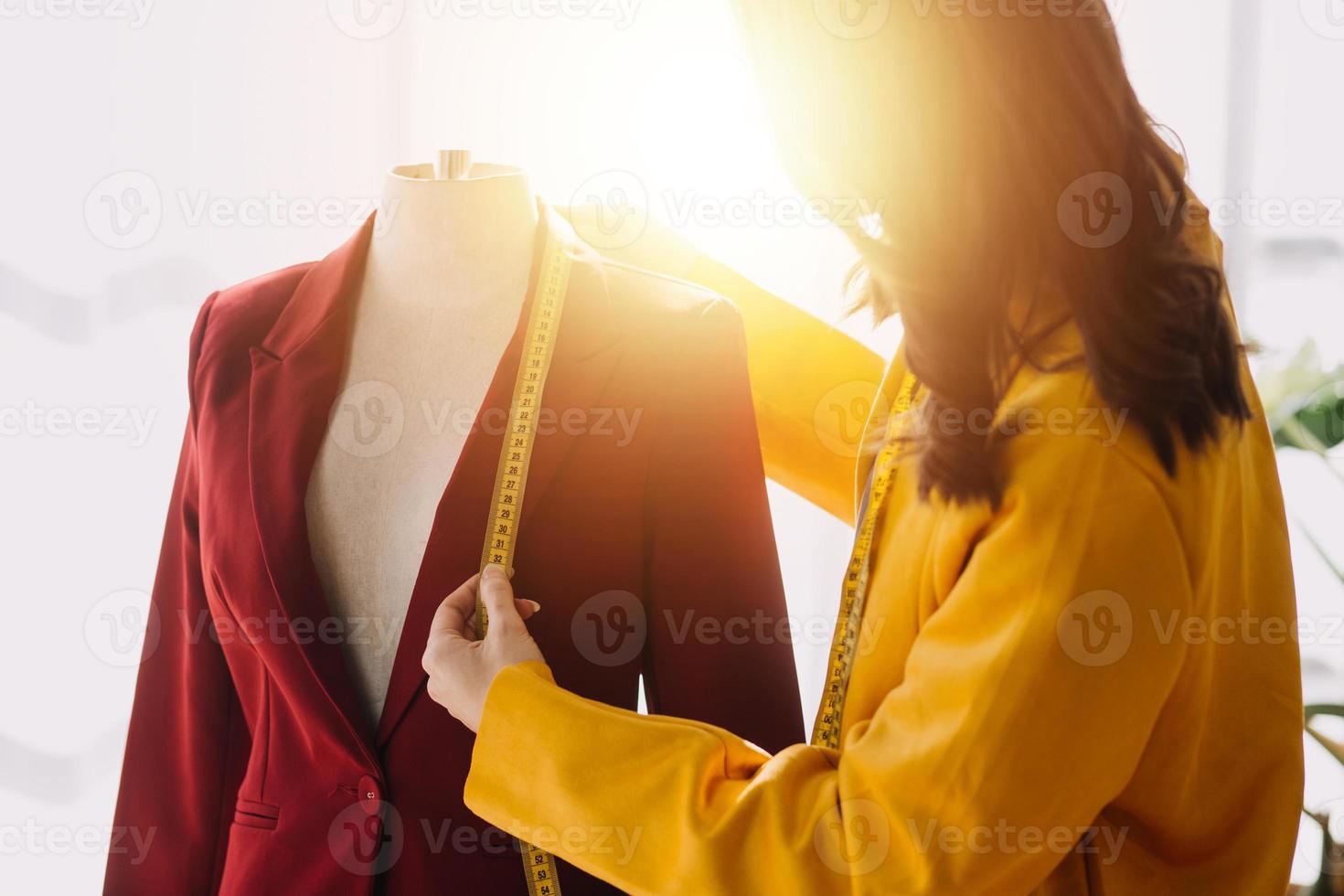Beautiful lady blogger showing clothes in front of the camera to recording vlog video live streaming at her shop. Online Shopping Cart notion. photo
