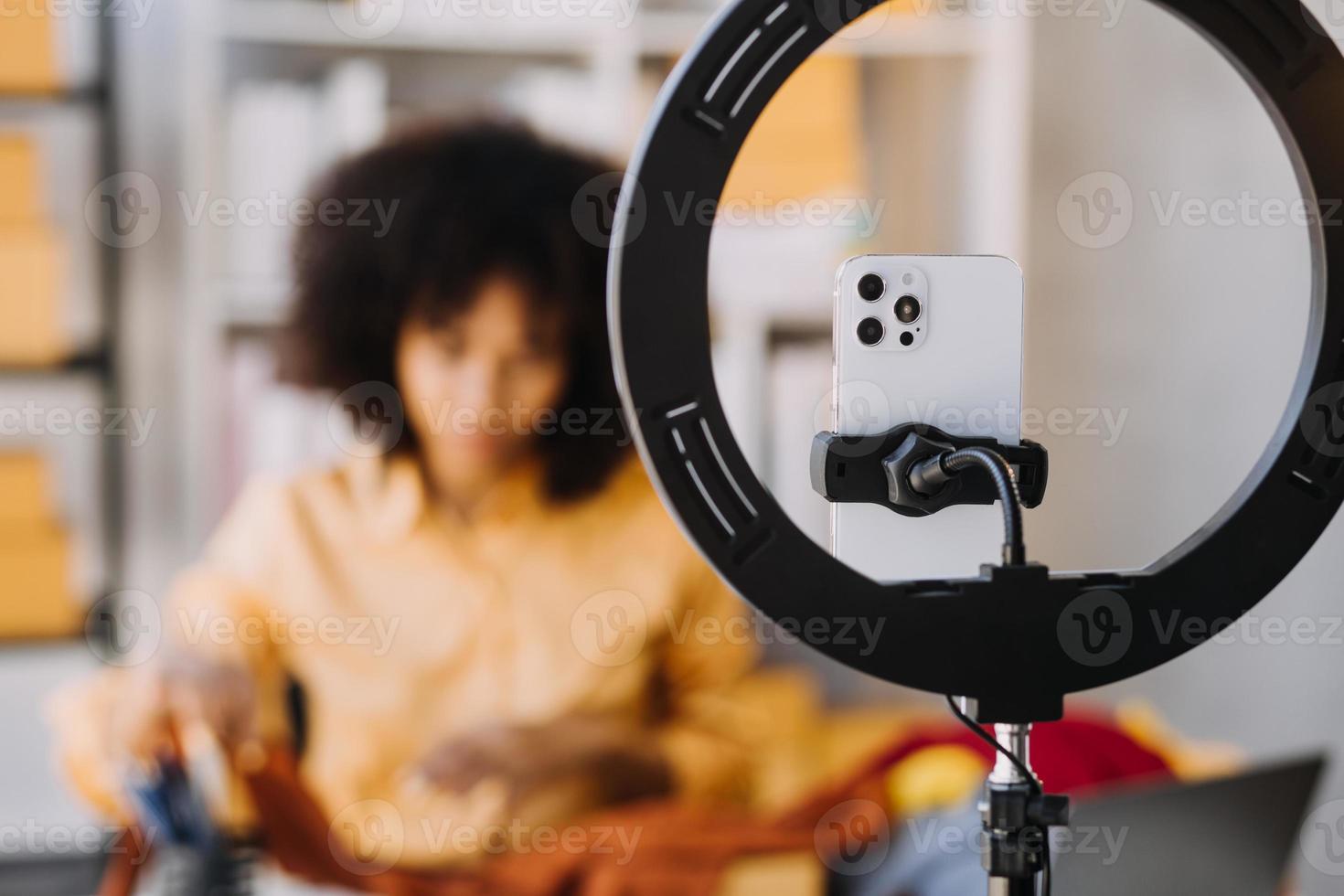 Diverse female fashion designers at work with tailor centimeters on necks and holds tablet and smartphone. independent creative design business. in studio photo
