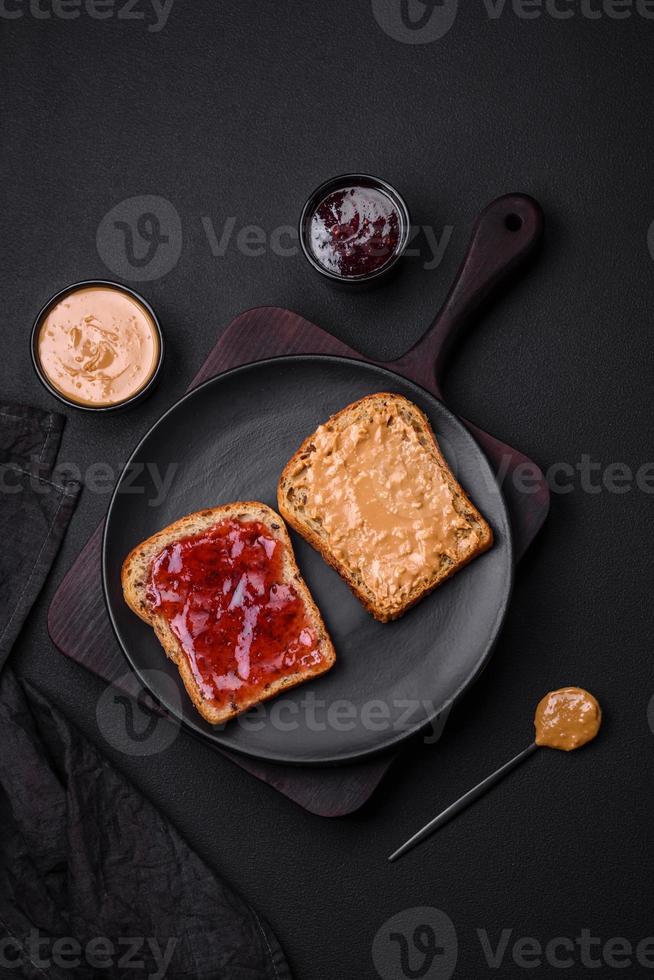 Nutritious sandwiches consisting of bread, raspberry jam and peanut butter photo