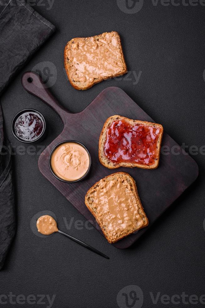 Nutritious sandwiches consisting of bread, raspberry jam and peanut butter photo