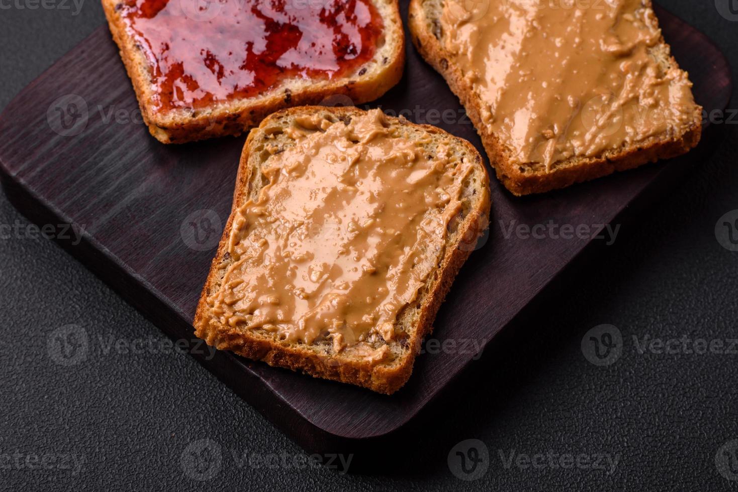 Nutritious sandwiches consisting of bread, raspberry jam and peanut butter photo