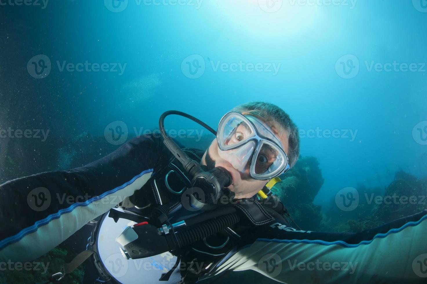 A scuba diver gone crazy try to open porthole from underwater photo