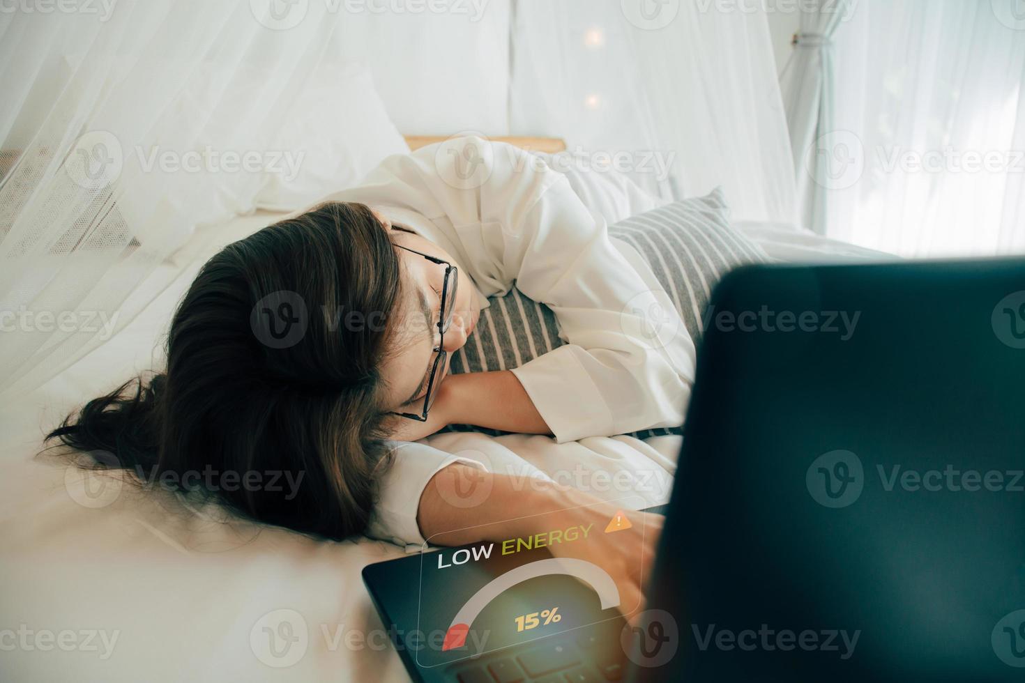 Freelance and remote work. Chronic fatigue syndrome and low power battery, Business woman sleeping over a laptop. Young tired woman fall asleep. Overworked, Level indicator of low energy remaining 15 photo