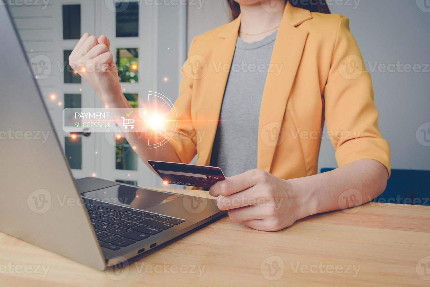 Online payment with wallet app technology. Business woman in yellow suit paying and shopping with computer laptop application. Digital money transfer, banking and e-commerce concept. photo