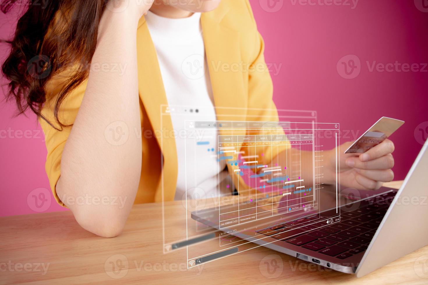 Woman holding credit card worried about the expend, pay bills online use laptop, makes household finances analysis, plans for spending money on home office, Save money for future, be provident concept photo