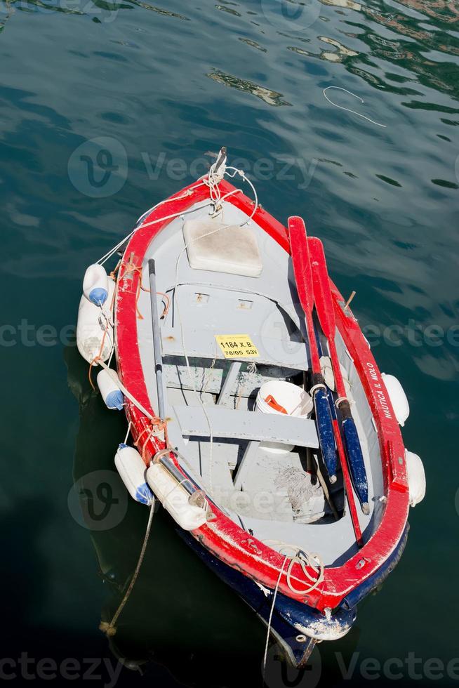 Fisherman wooden boat mooring near the harbour photo