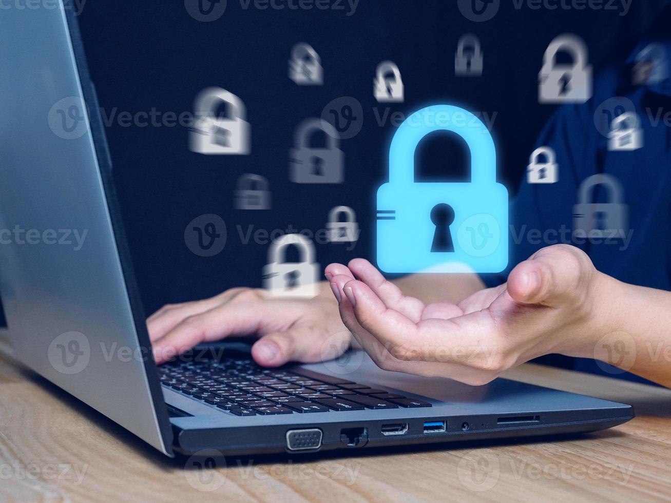 cyber security concept Man's hand showing padlock icon, security, among blurred padlock icons. Internet crime prevention, data theft photo