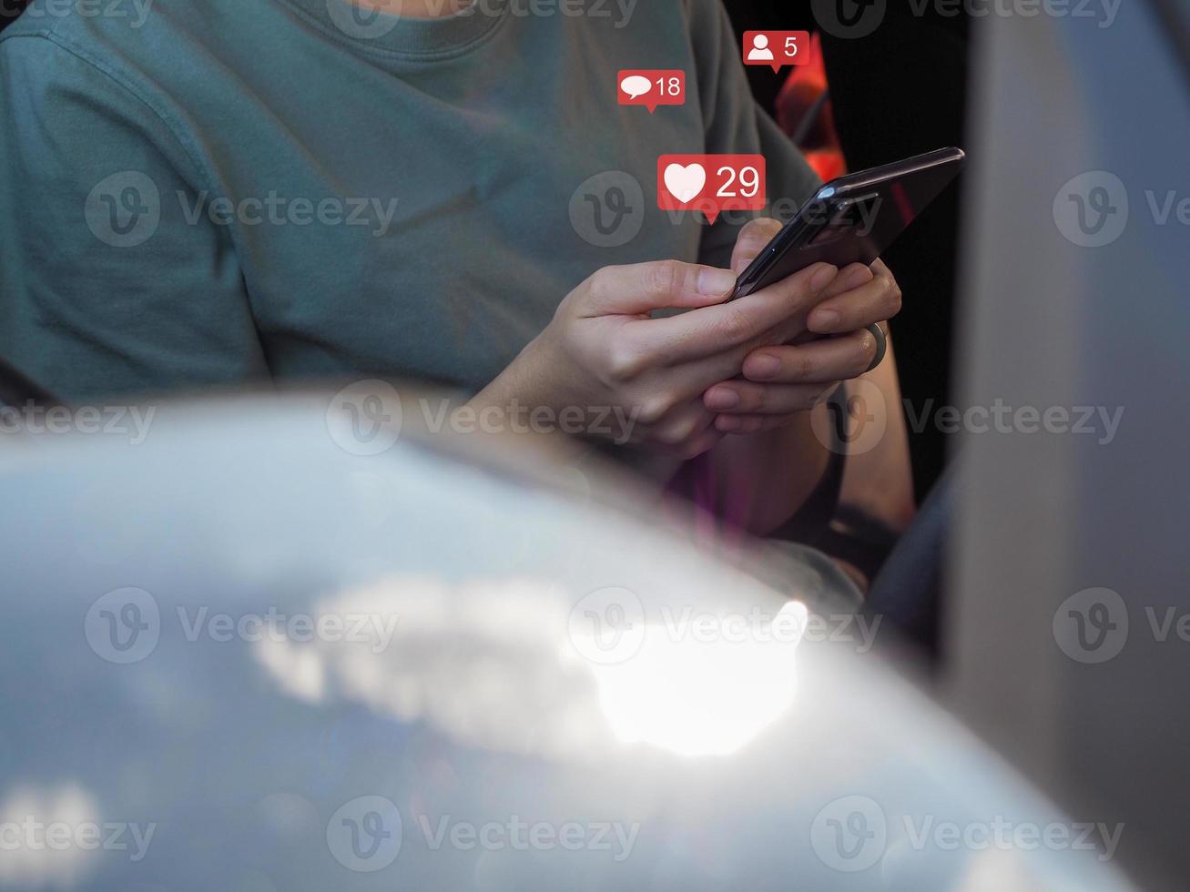 Young woman playing social media on her smartphone in the car. photo