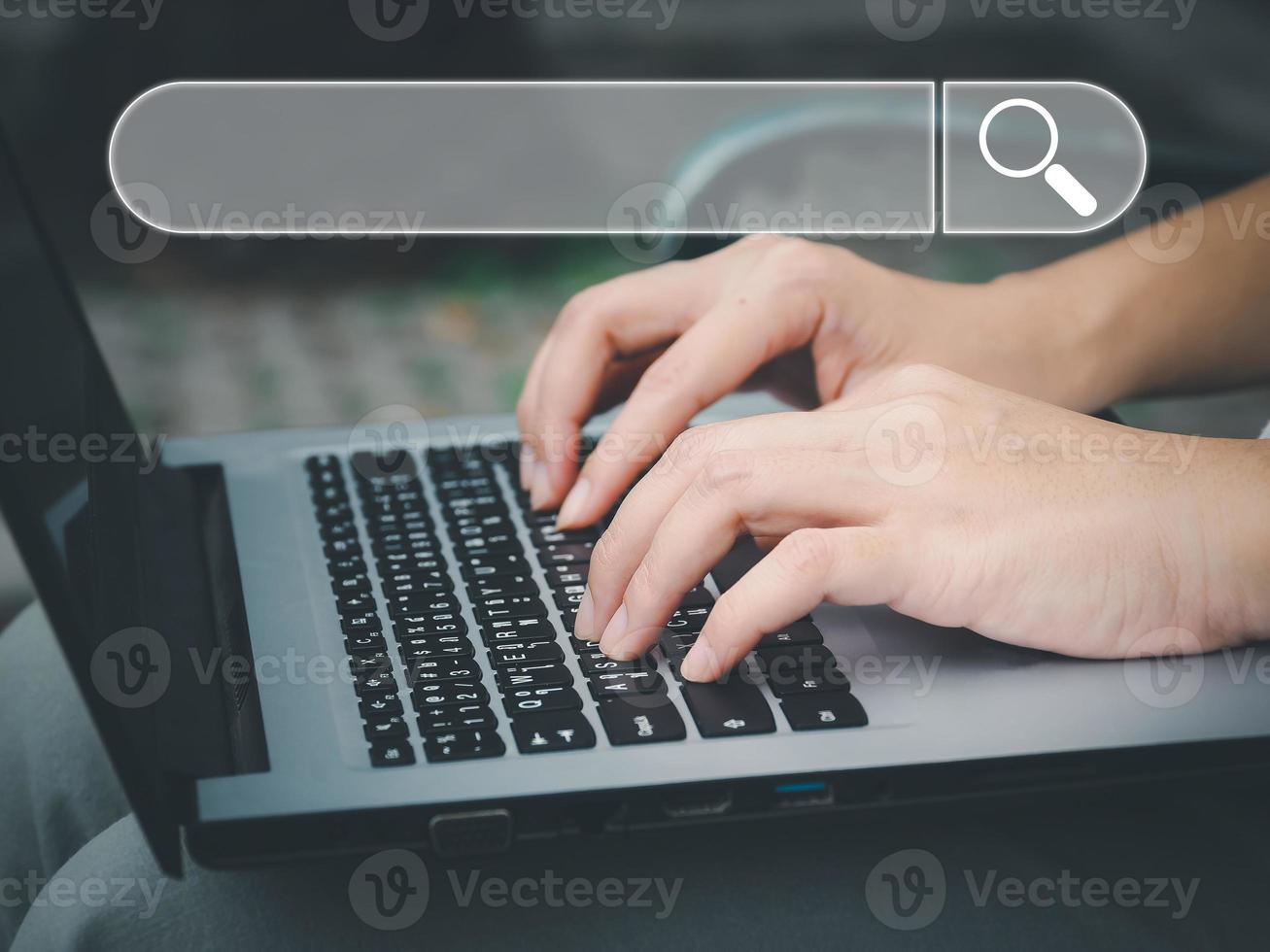 Search a young woman using a laptop to search for information using Search Console, a large database technology access to information. photo