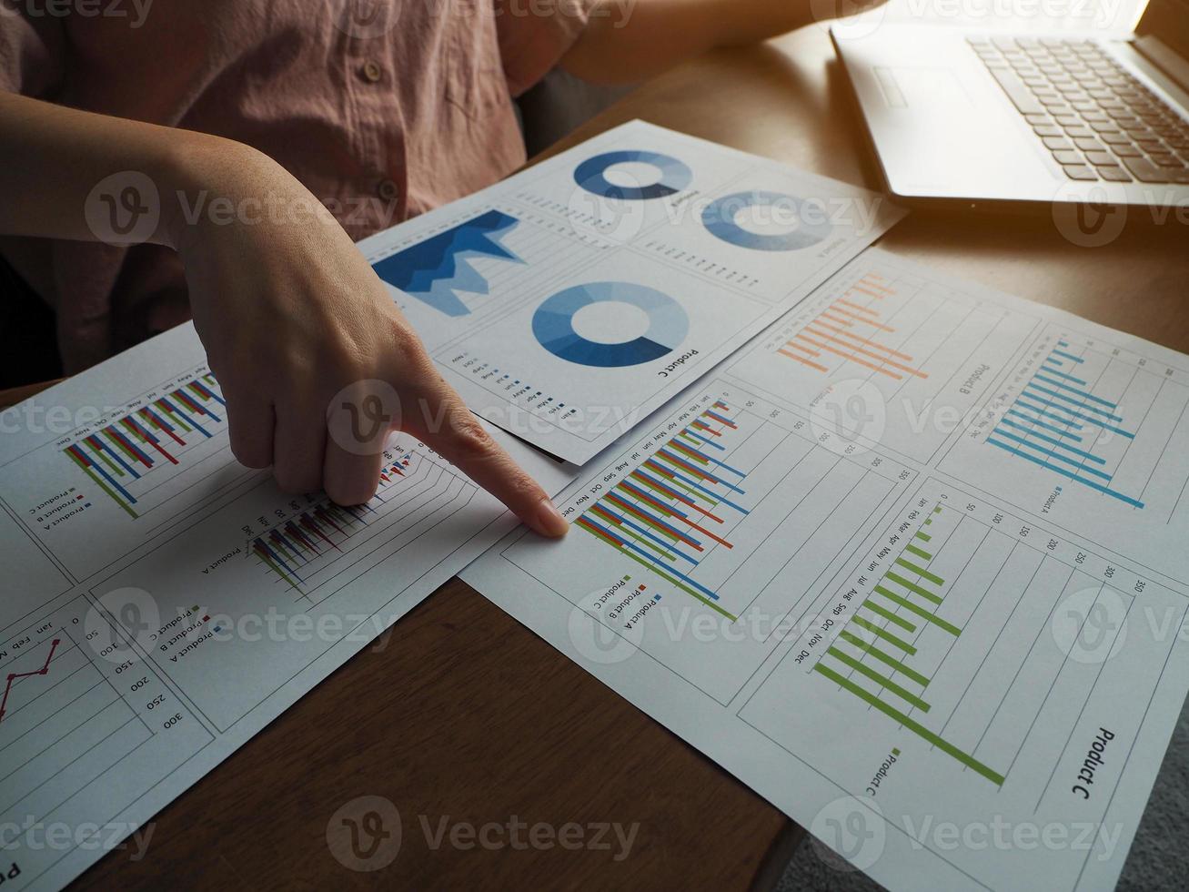 Businesswoman pointing at a graph online meeting planning to work working from home photo