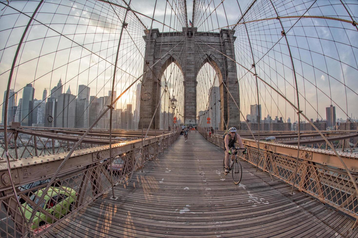 NEW YORK - USA - JUNE, 12 2015 people crossing manhattan bridge photo