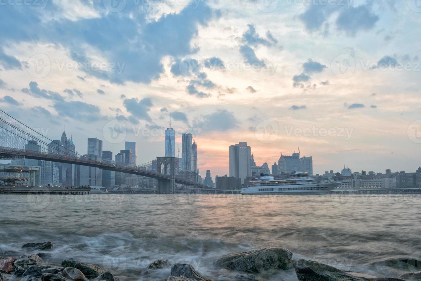 sunset under manhattan bridge in new york photo