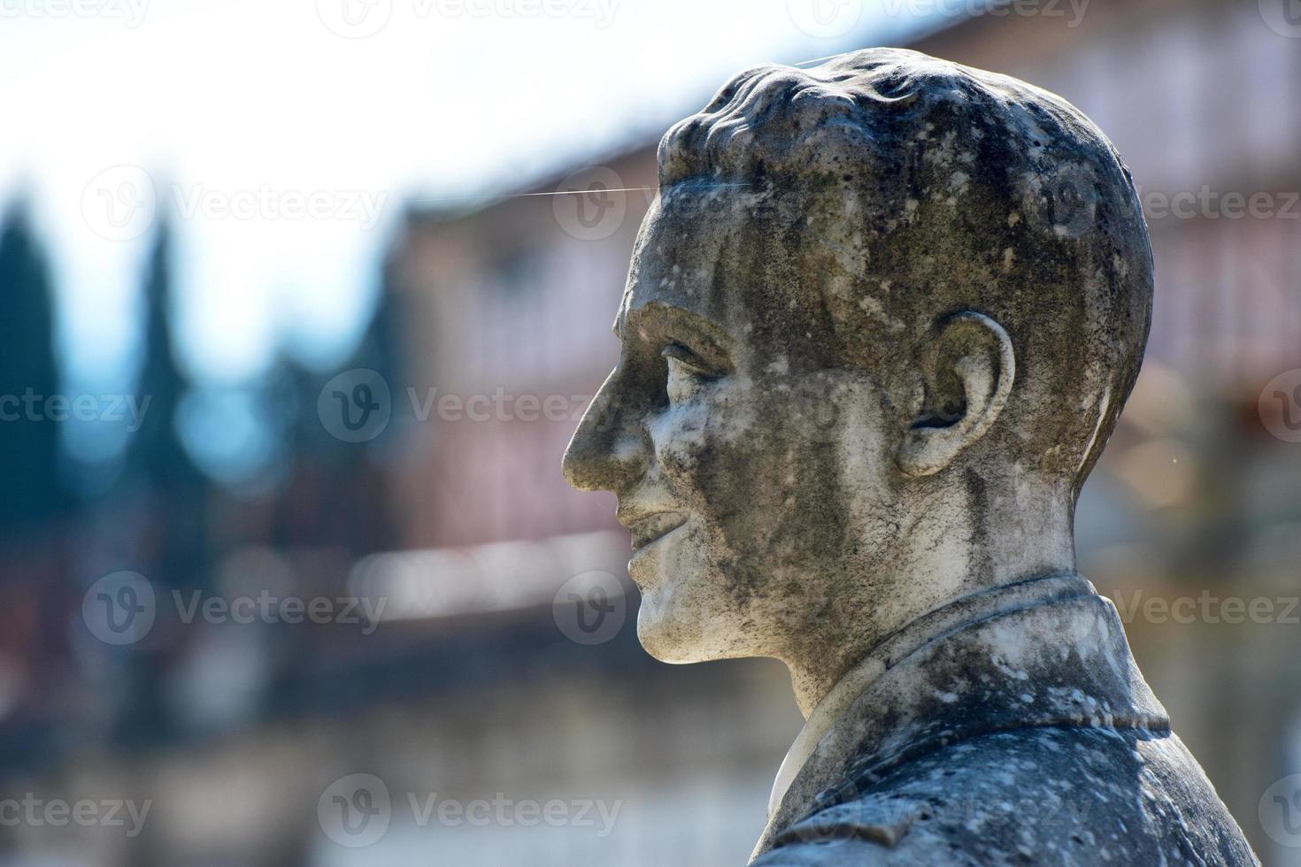 young lovers while smiling marble statue photo